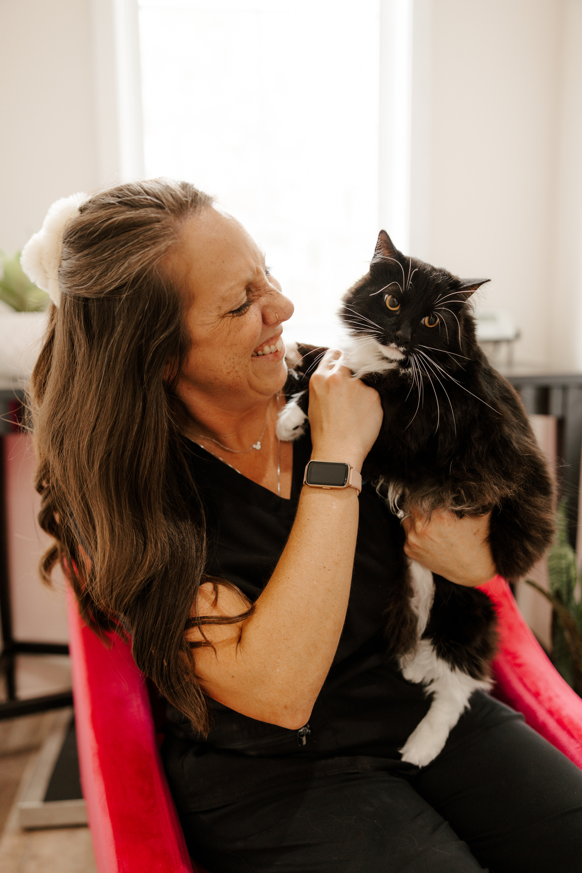 woman smiling and holding a cat